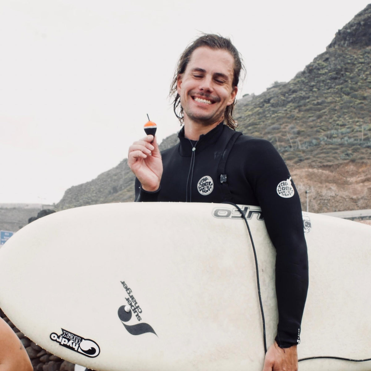 Gründer von 20knots Phil mit Surfboard unter dem Arm